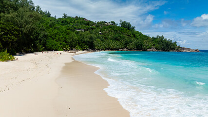 Sandy beach featuring turquoise waters and dense green foliage. Anse Intendance. Seychelles, Mahe.