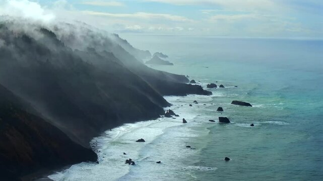 Rugged coastline Lost Coast Trail surf waves USAL Beach campground 4wd aerial drone California cloud layer blue sky mist rain fog PNW waves morning Chimney Rocks nature landscape circle right motion