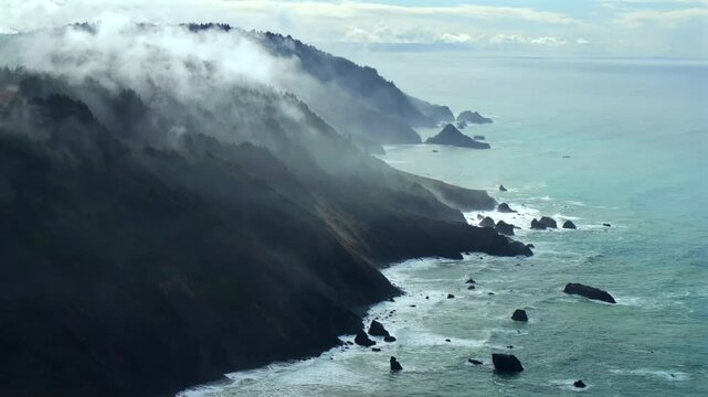Rugged coastline Lost Coast Trail USAL Beach campground 4wd black sand mist rain fog aerial drone California PNW sun rays waves crashing cloud layer morning Chimney Rocks scenic flight circle right