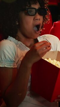 Young woman watching scary movie