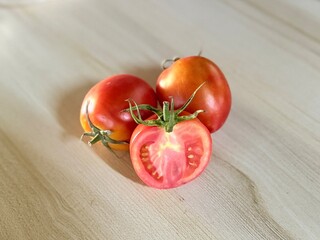 Whole, halved, bright red tomatoes.