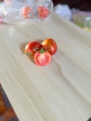 Whole, halved, bright red tomatoes.