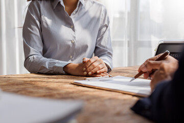 Hands of recruiter holding resume in front of candidate at desk.employee job application concept.