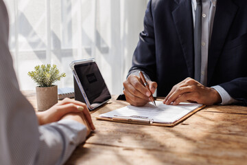 Hands of recruiter holding resume in front of candidate at desk.employee job application concept.