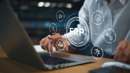 Woman using laptop with erp system interface overlaid