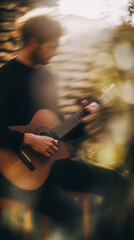 Obraz premium Male musician playing acoustic guitar in warm, artistic ambience