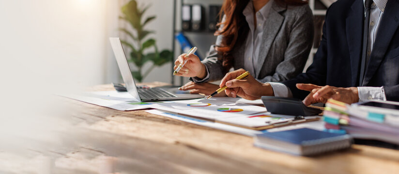Title: Businessman team working at office with document on his desk, doing planning analyzing the financial report, business plan investment, finance analysis concept. Economic business discussions.

