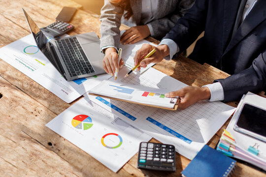 Title: Businessman team working at office with document on his desk, doing planning analyzing the financial report, business plan investment, finance analysis concept. Economic business discussions.

