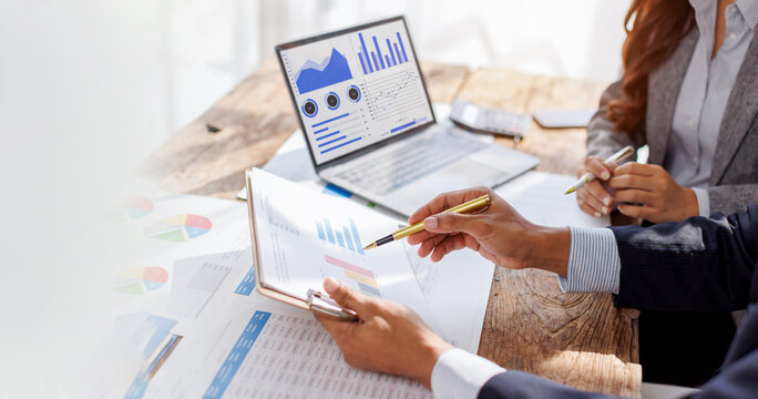 Title: Business people Consulting meeting working and brainstorming new business project, using tablet and laptop at desk office.

