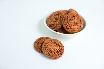delicious chocolate biscuits in round shape in plate isolated on white background