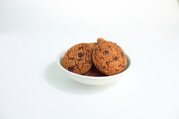 delicious chocolate biscuits in round shape in plate isolated on white background