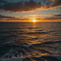 Obraz premium A breathtaking sunset over a calm ocean with golden reflections.
