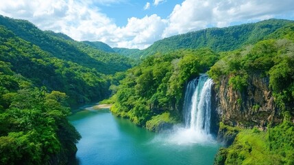 Fototapeta premium Lush green landscape with a serene waterfall cascading into a tranquil river.