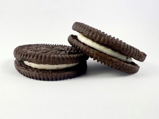 Chocolate biscuits filled with vanilla cream isolated on white background