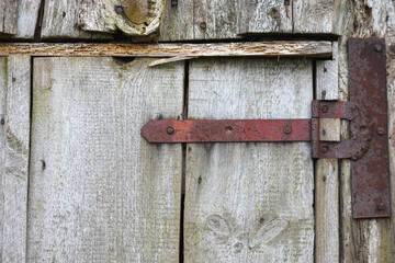 
an old wooden door with metal hinges that is part of some building.