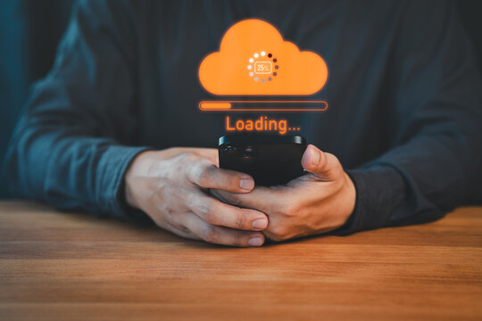 Person holding a smartphone with a glowing orange cloud upload icon and loading progress bar, representing cloud computing, data transfer, internet of things, and digital technology.