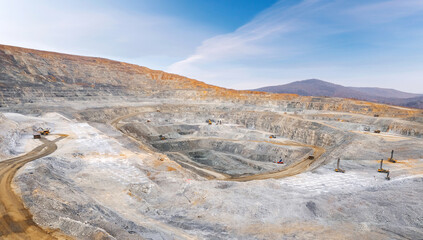 Panoramic of open pit mine industry, aerial view. Big yellow mining truck for coal working in quarry