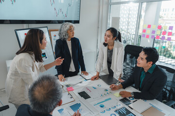 Business team analyzing financial charts and graphs, collaborating on innovative strategies, and brainstorming ideas for growth and success in a dynamic office environment