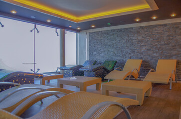 Thermal suite relaxation loungers chairs in clean modern design in spa or wellness thermal suite area on modern luxury cruiseship or cruise ship liner with panoramic windows ocean views