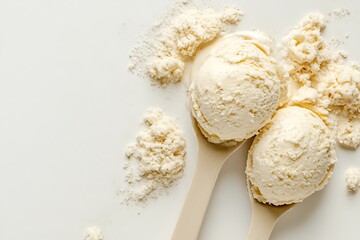 Fototapeta premium Scoops of vanilla ice cream with cocoa powder on white background