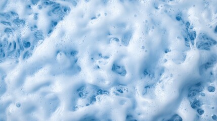 Obraz premium Powerful ocean waves break into frothy white crests, creating a mesmerizing pattern on the deep blue water with open space on the right for potential text