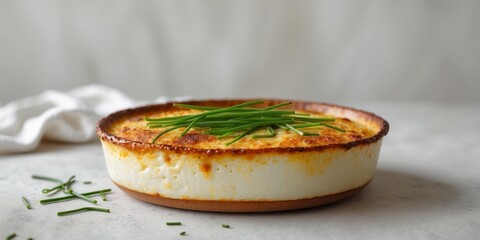 Golden Brown Baked Dish with Creamy Texture and Chives Garnish.
