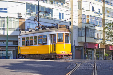Obraz premium Travel Ideas. Closeup of Outdated Retro Vintage Yellow Ancient Tram Tramway on Streets of Lisbon in Portugal