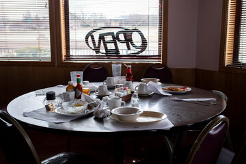 A table in a restaurant after people have finished eating