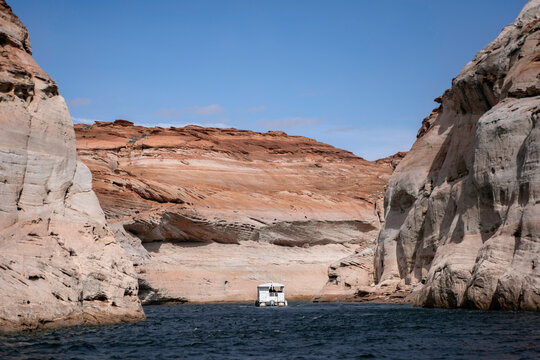 A pontoon boat navigates a rocky channel