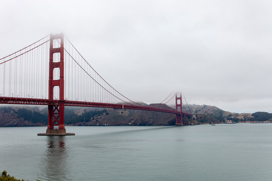 Golden Gate bridge on a foggy morning space on right