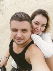 Fototapeta premium Young adult couple is taking a selfie on a scooter