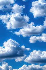 Fototapeta premium A bright blue sky filled with fluffy white clouds, creating a serene and peaceful atmosphere.