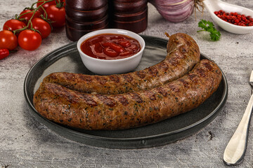 Grilled beef sausages with sauce
