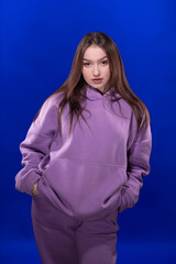 Young girl posing and moving on a blue background	