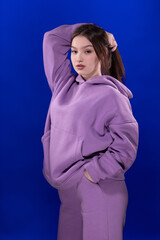 Young girl posing and moving on a blue background	