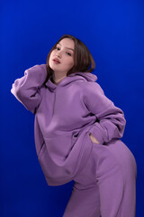 Young girl posing and moving on a blue background	