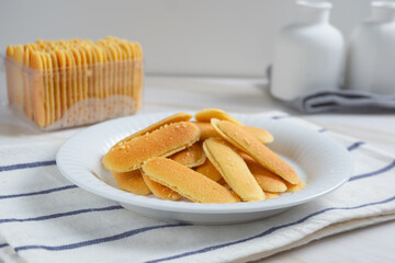 Kue lidah kucing or cat's tongue cookies. Traditional cookies for eid holiday in Indonesia. Perfect for recipe, article, catalogue, or any commercial purposes.