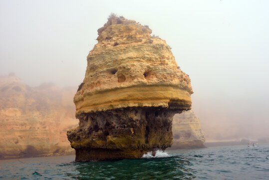 foggy landscape, the Algarve rock formation  is a unique and amazing natural wonder located in the coastal town of Porches, Portugal