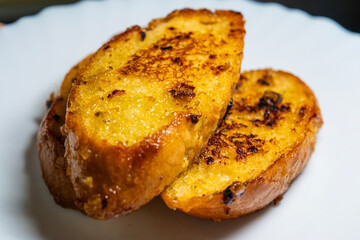 slice of the roasted garlic baguette on the dish