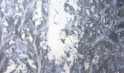 Obraz premium Frozen pattern of hoarfrost and frostwork structure on the glass. Color texture photo for background.