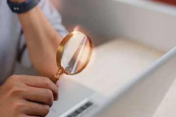 businessman looking at data chart dashboard in concept of investment data analysis and DMS document audit financial Tax Fraud audit Using Magnifying Glass.