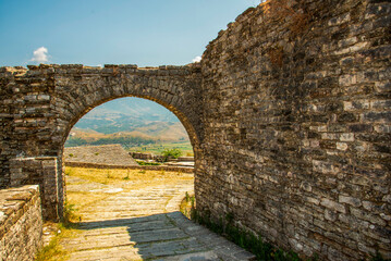 Stone Archway Framing Albania’s Drino Valley at Gjirokaster Castle: A UNESCO-Listed Fortress Gateway in the Heart of the Balkan Highlands