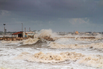 Powerful Waves Crashing Against Beach Breakwater During Stormy Weather