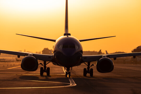 Airliner arriving into gate at sunset.