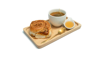 Hot tea and homey with pork floss and chili paste bread on isolated white backgrouind.