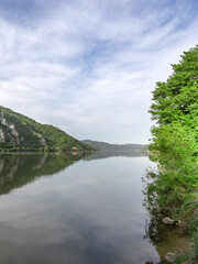 Fototapeta premium Calm lake with a cloudy sky in the background