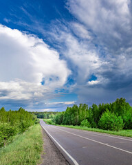 Road with a cloudy sky in the background
