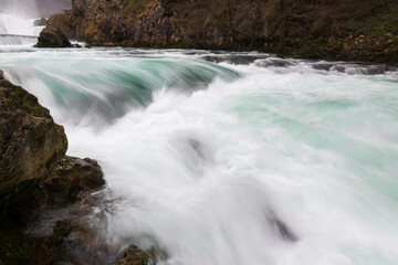 Obraz premium Waterfall and cascade on Una river, water sprays and flows in motion blur, turquoise colour