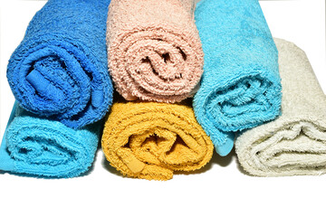 Terry short hand towels lie in a stack on a white background.