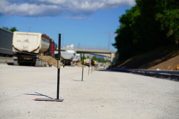 Measuring a straight line on a road construction site, ensuring precision and alignment for the...